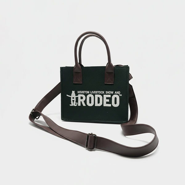 Dark green canvas tote bag with brown leather handles and Houston Livestock Show and Rodeo text - Uhorse